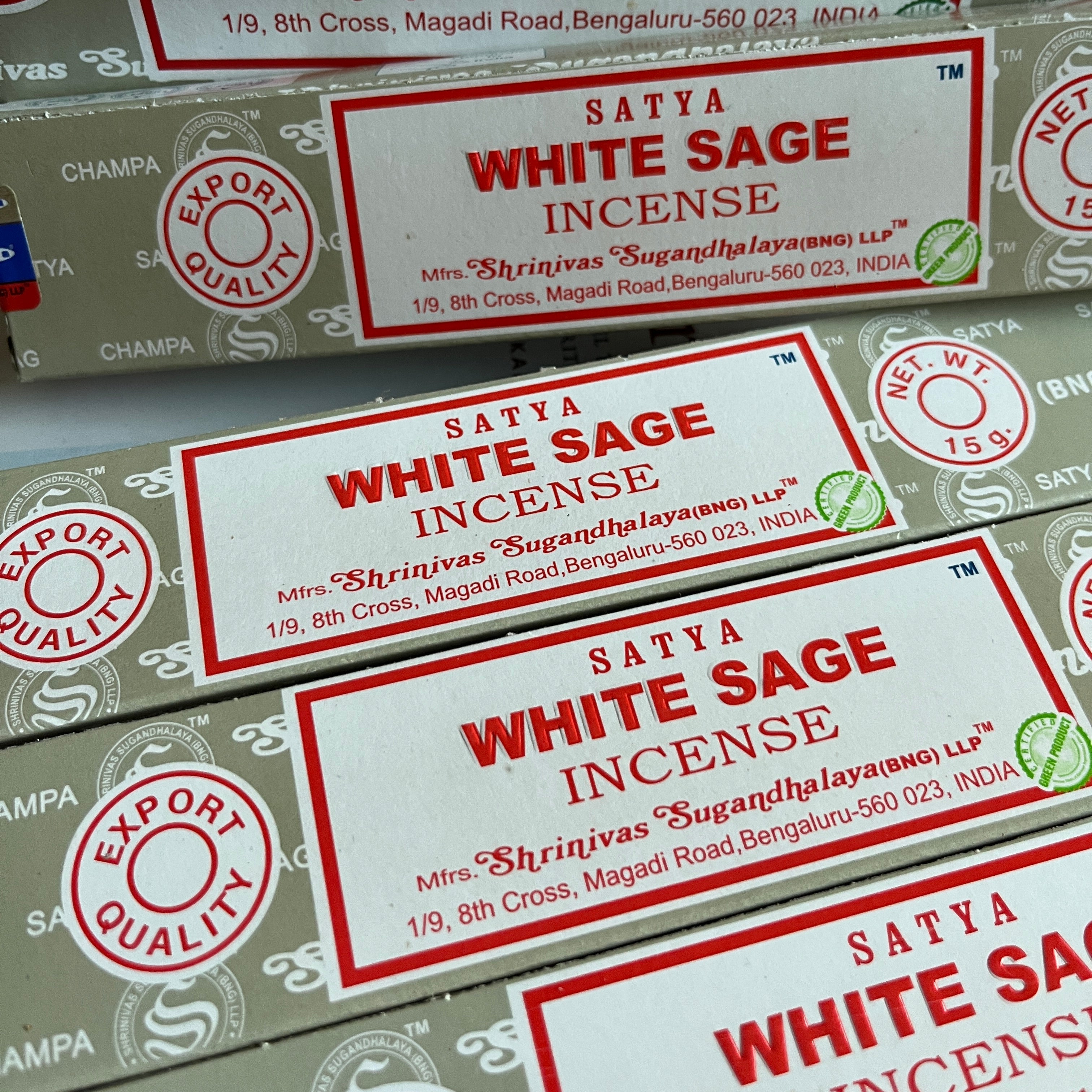 Multiple boxes of Satya White Sage Incense with red and white labels.
