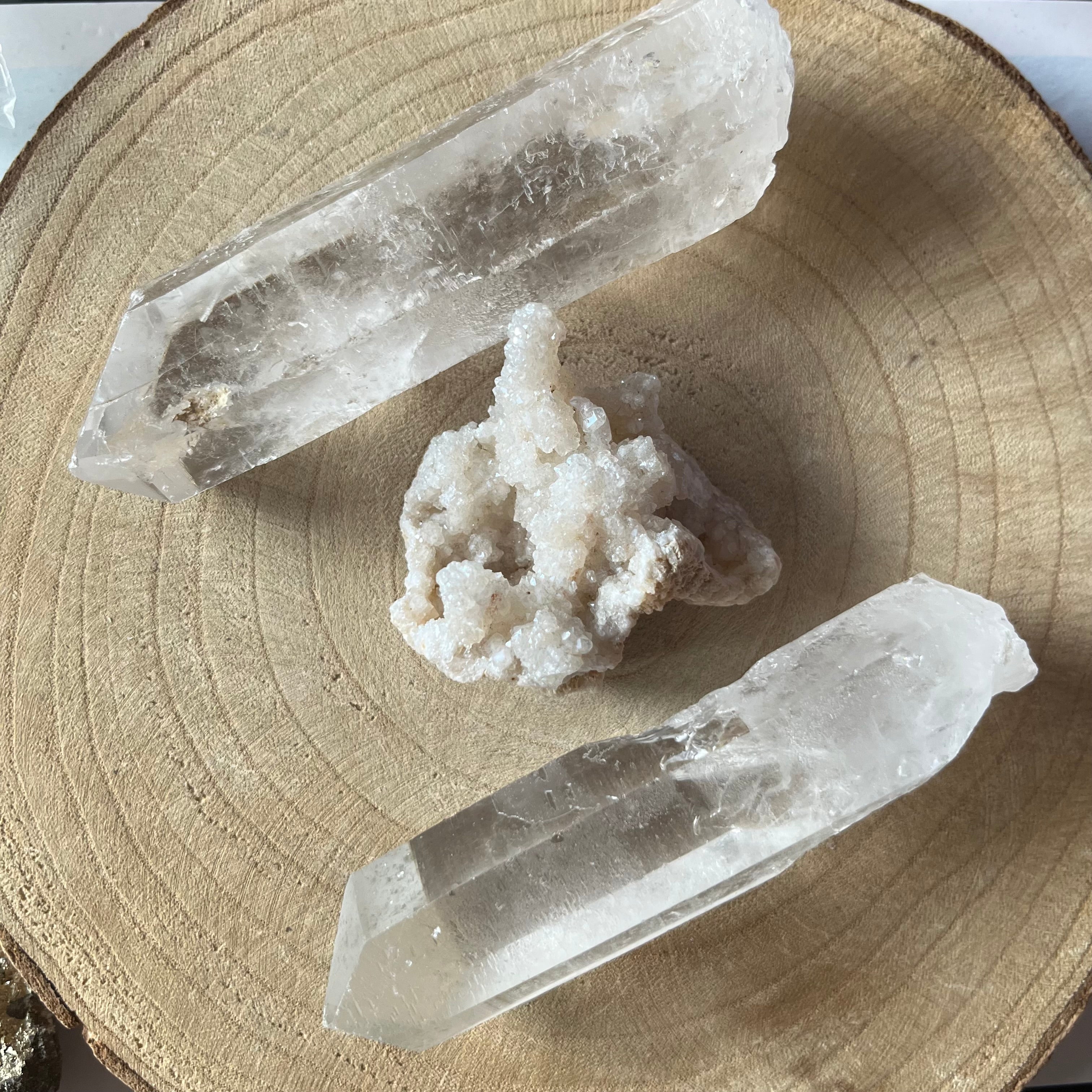 Two crystal formations on a wooden surface