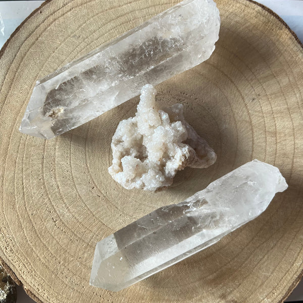 Two crystal formations on a wooden surface