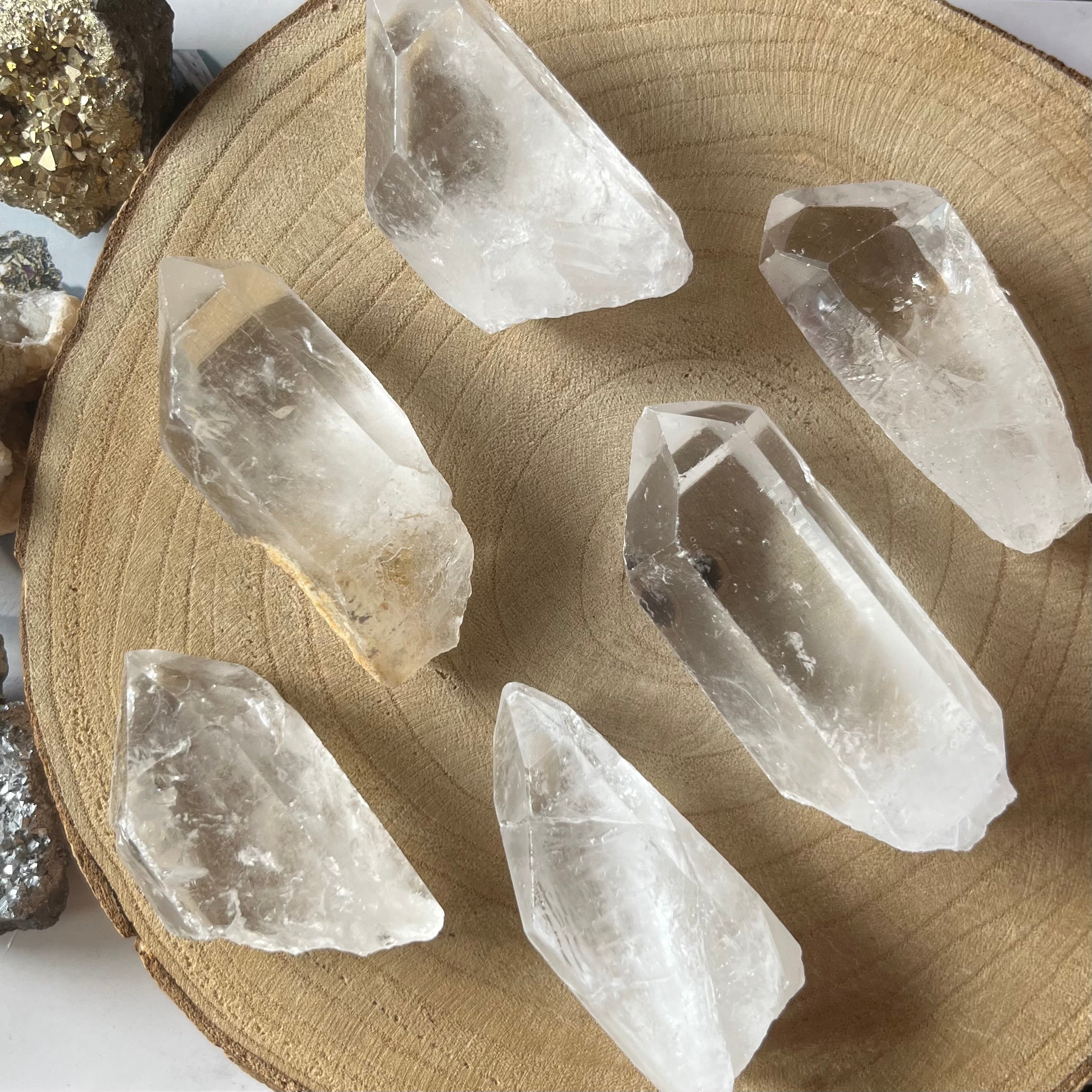 Clear crystal points on a wooden surface