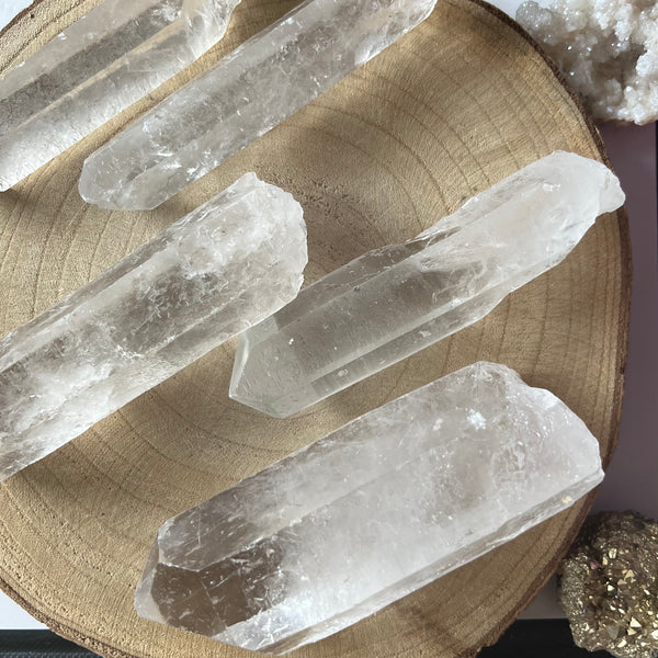 Clear crystal sticks on a wooden surface