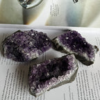 Amethyst crystal formations on a book
