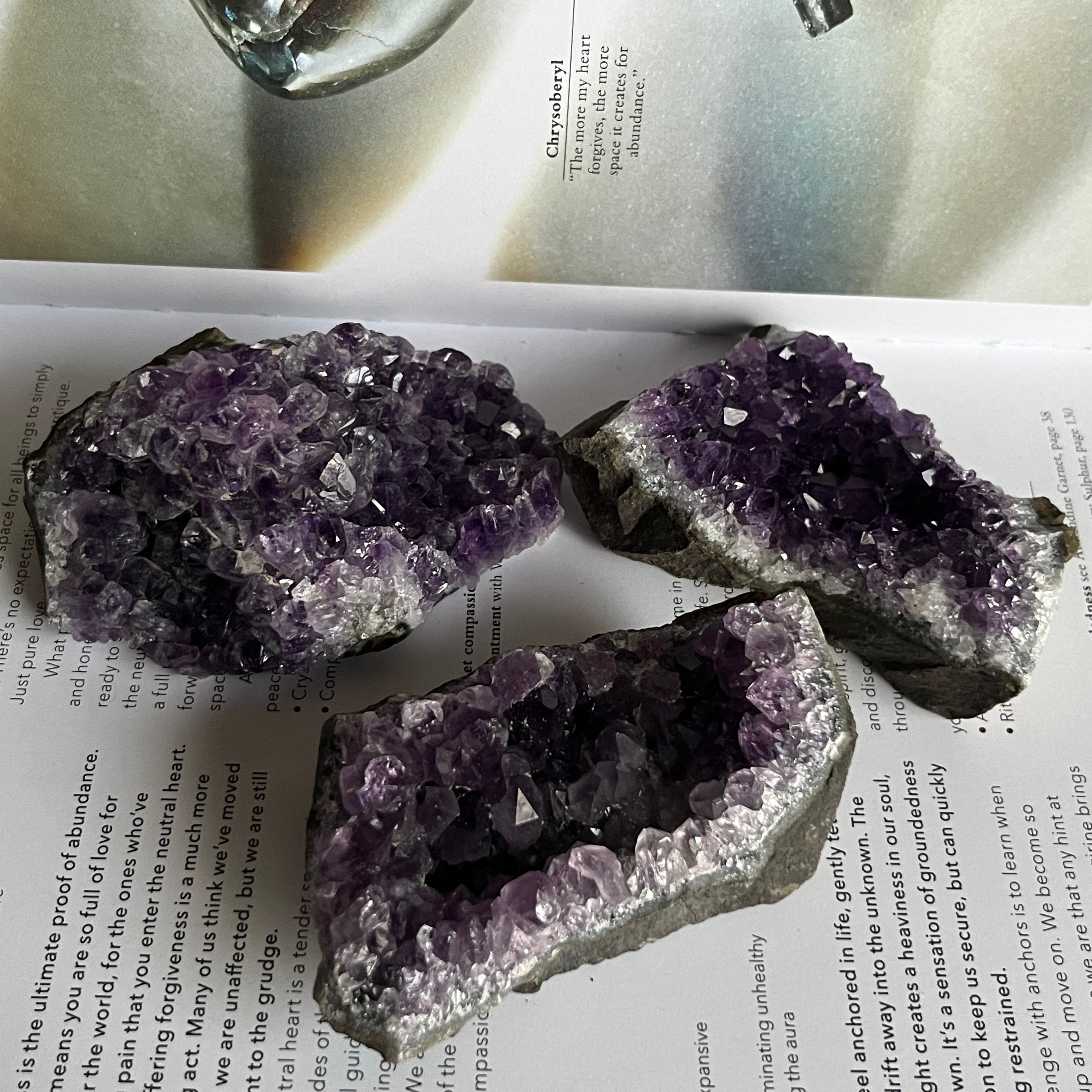 Amethyst crystal formations on a book