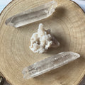 Crystal rock and two crystal points on a wooden surface