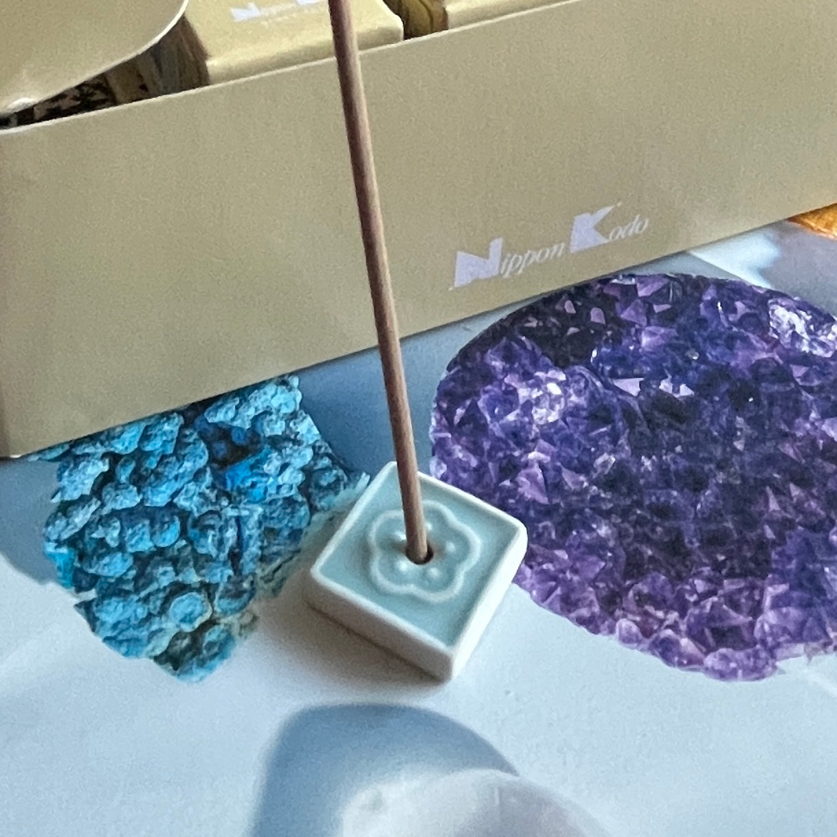 Incense stick in a holder with a Nippon Kodo box in the background