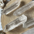 Clear crystal sticks on a wooden surface