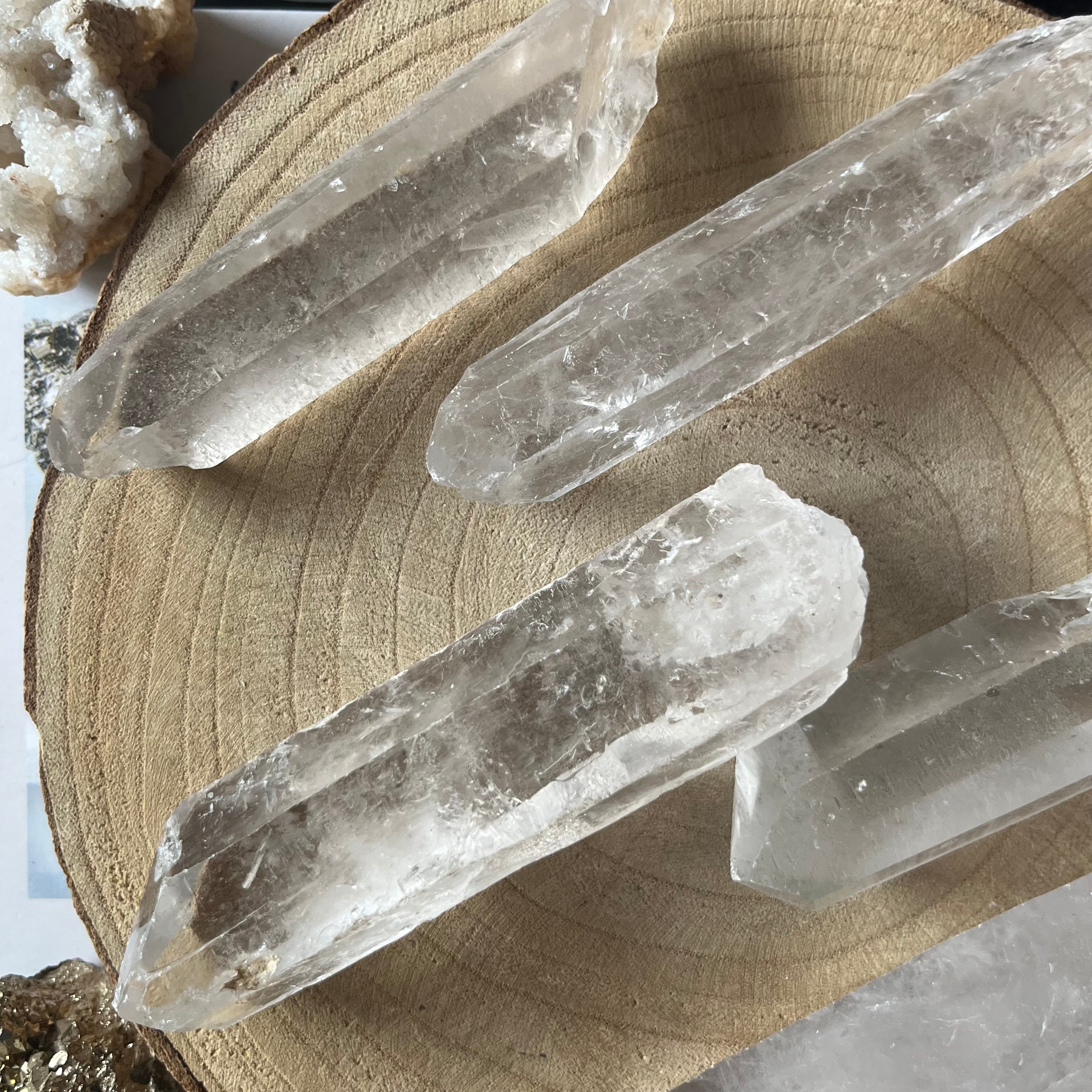 Clear crystal sticks on a wooden surface