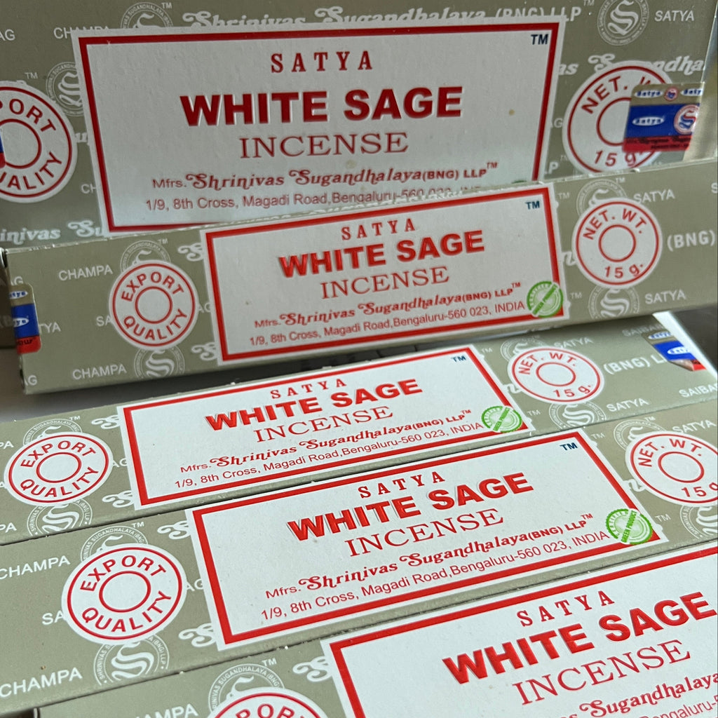 Multiple boxes of Satya White Sage Incense on a white background