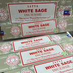 Multiple boxes of Satya White Sage Incense on a white background