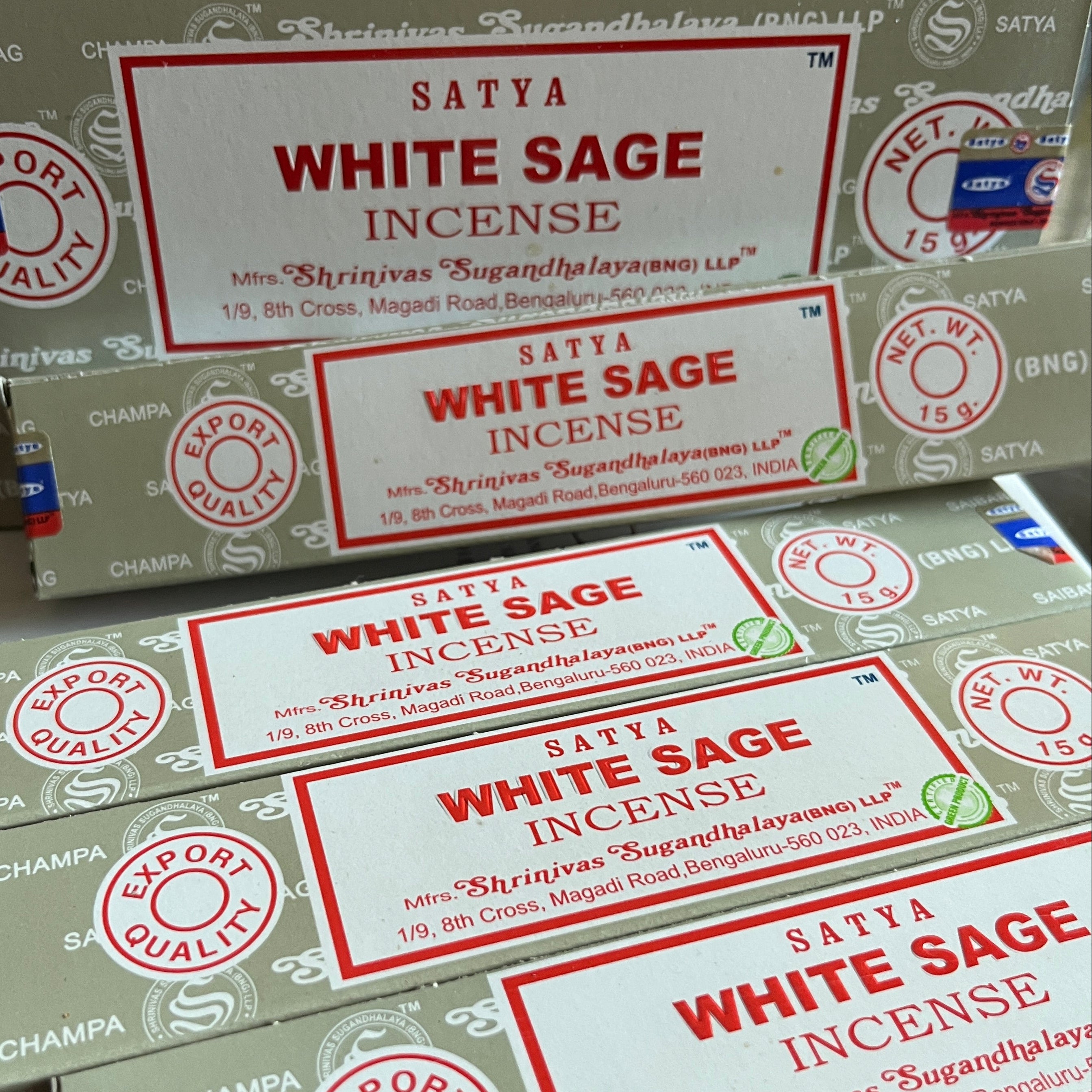 Multiple boxes of Satya White Sage Incense on a white background