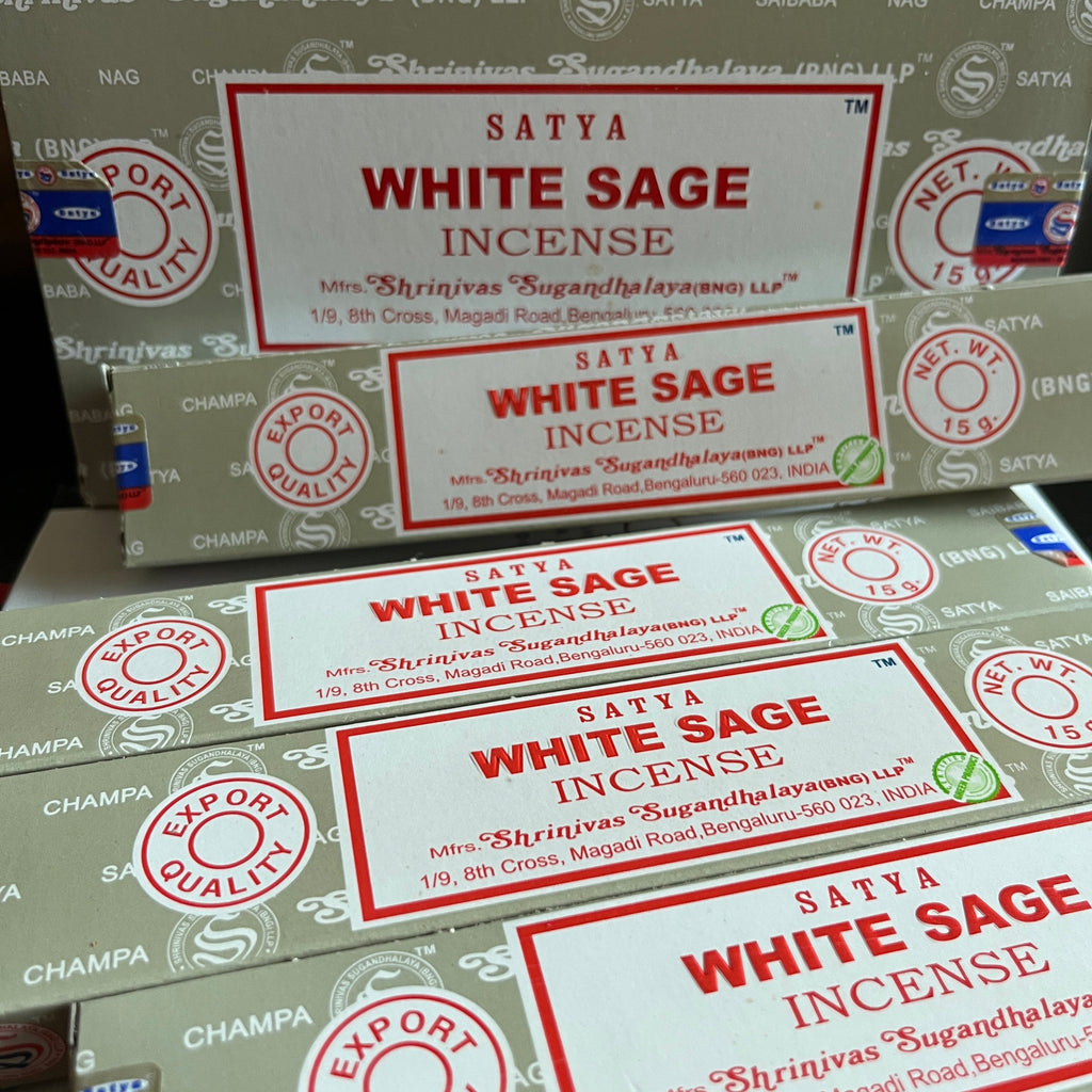 Multiple boxes of Satya White Sage Incense with visible branding.