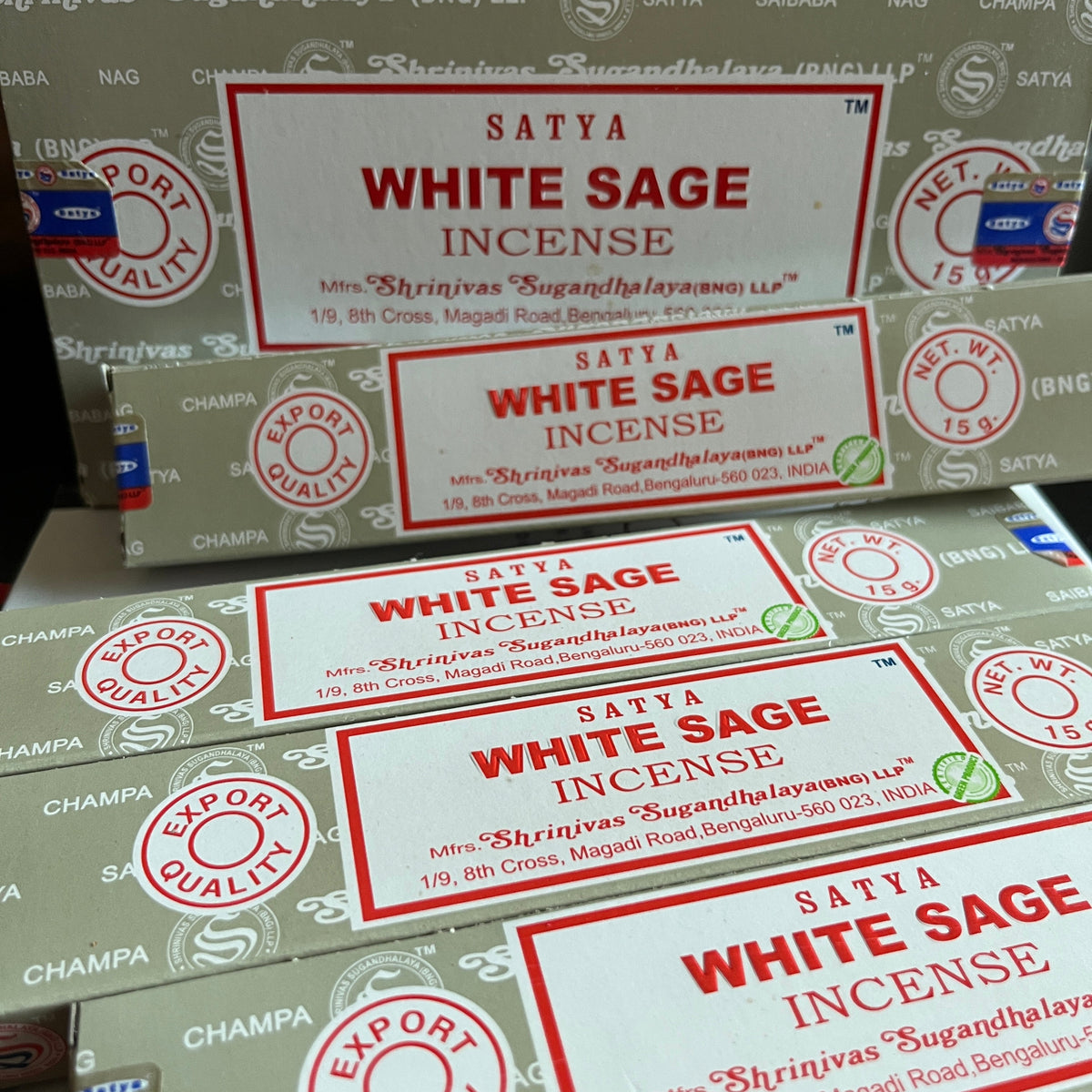 Multiple boxes of Satya White Sage Incense with visible branding.