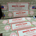 Multiple boxes of Satya White Sage Incense with visible branding.