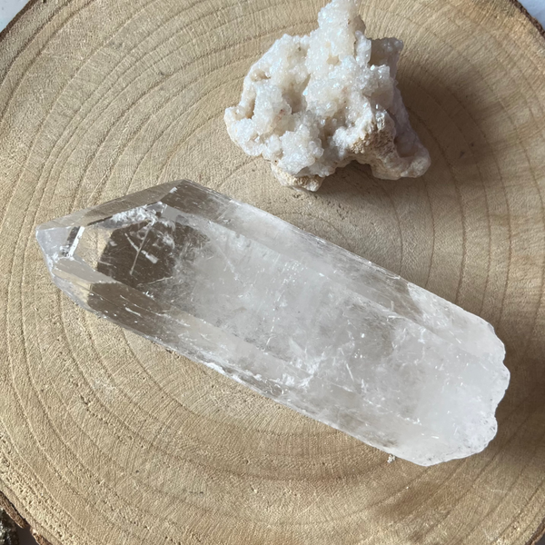 Crystal and white crystal cluster on a wooden surface