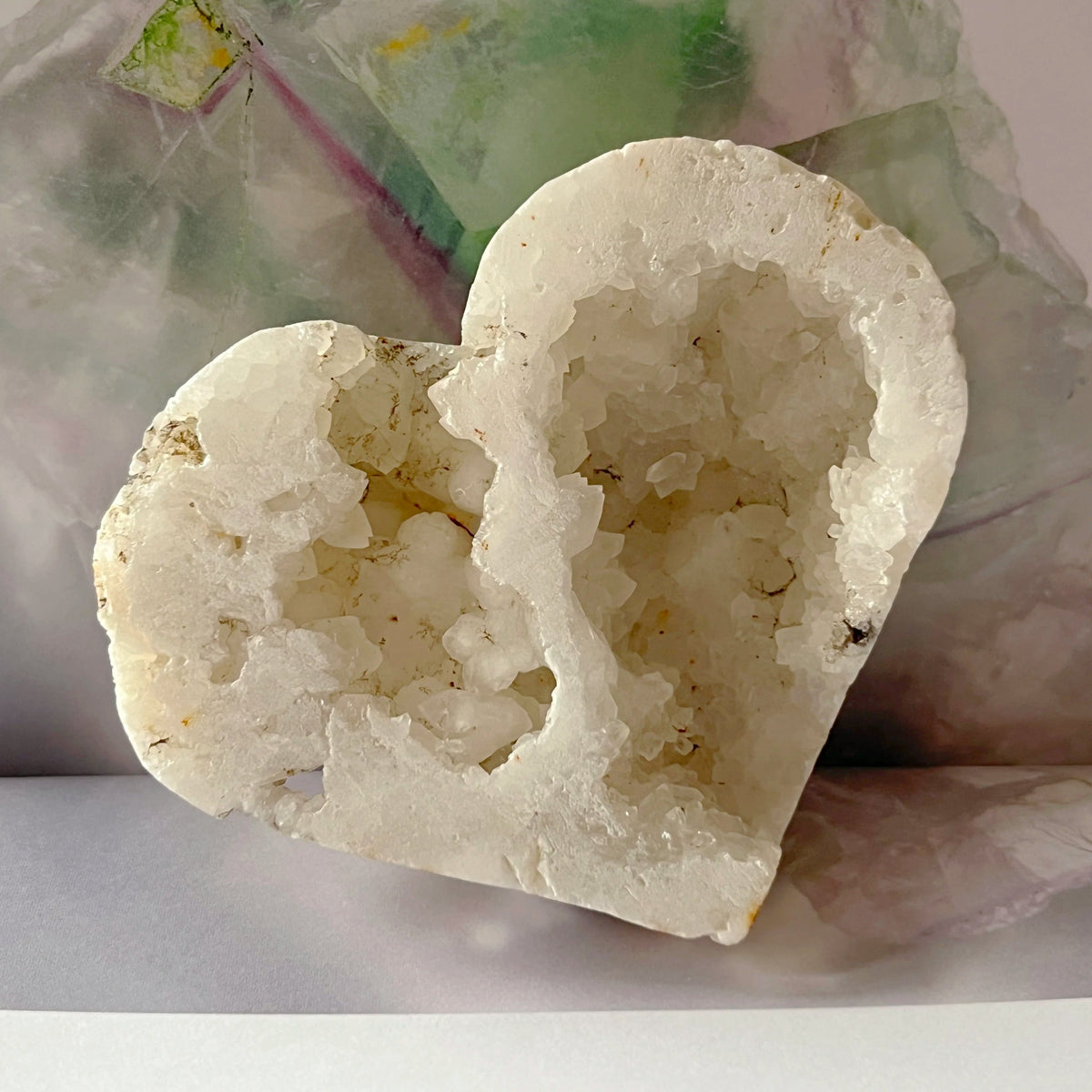 Heart-shaped crystal geode on a plain background