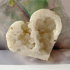 Heart-shaped crystal geode on a plain background