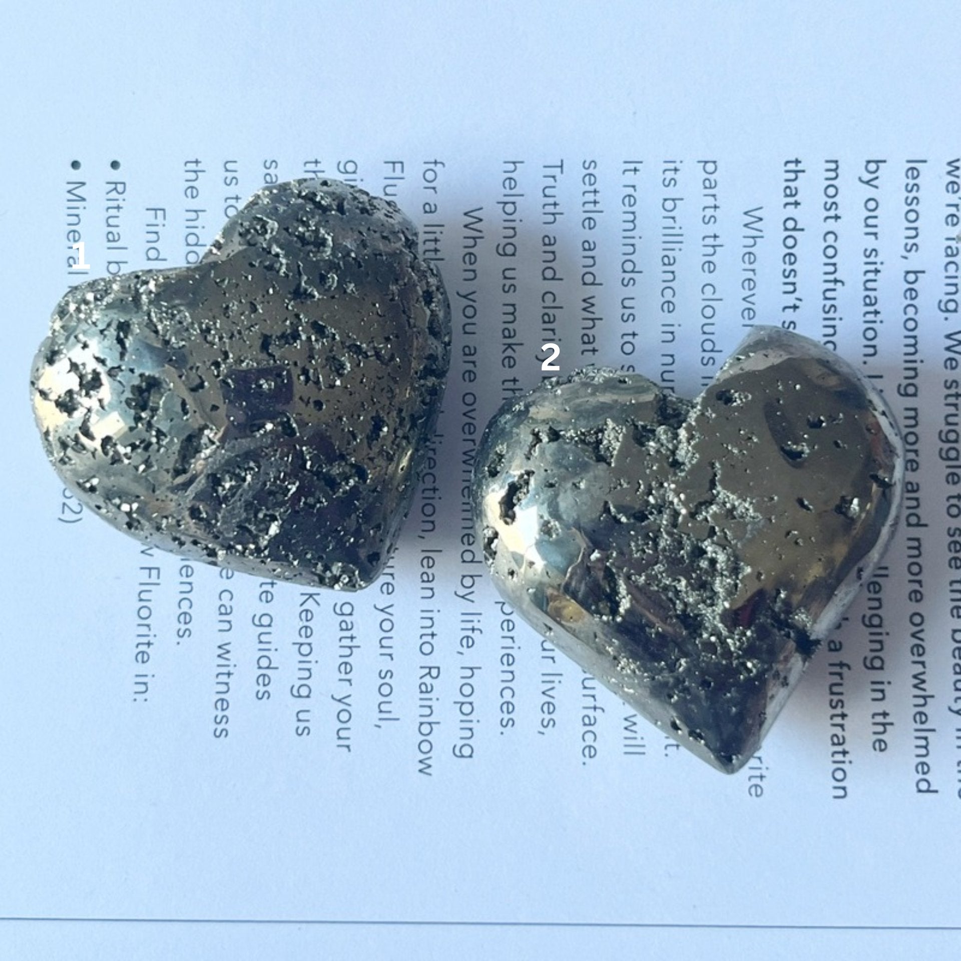 Pyramid heart held in a hand with a printed document in the background