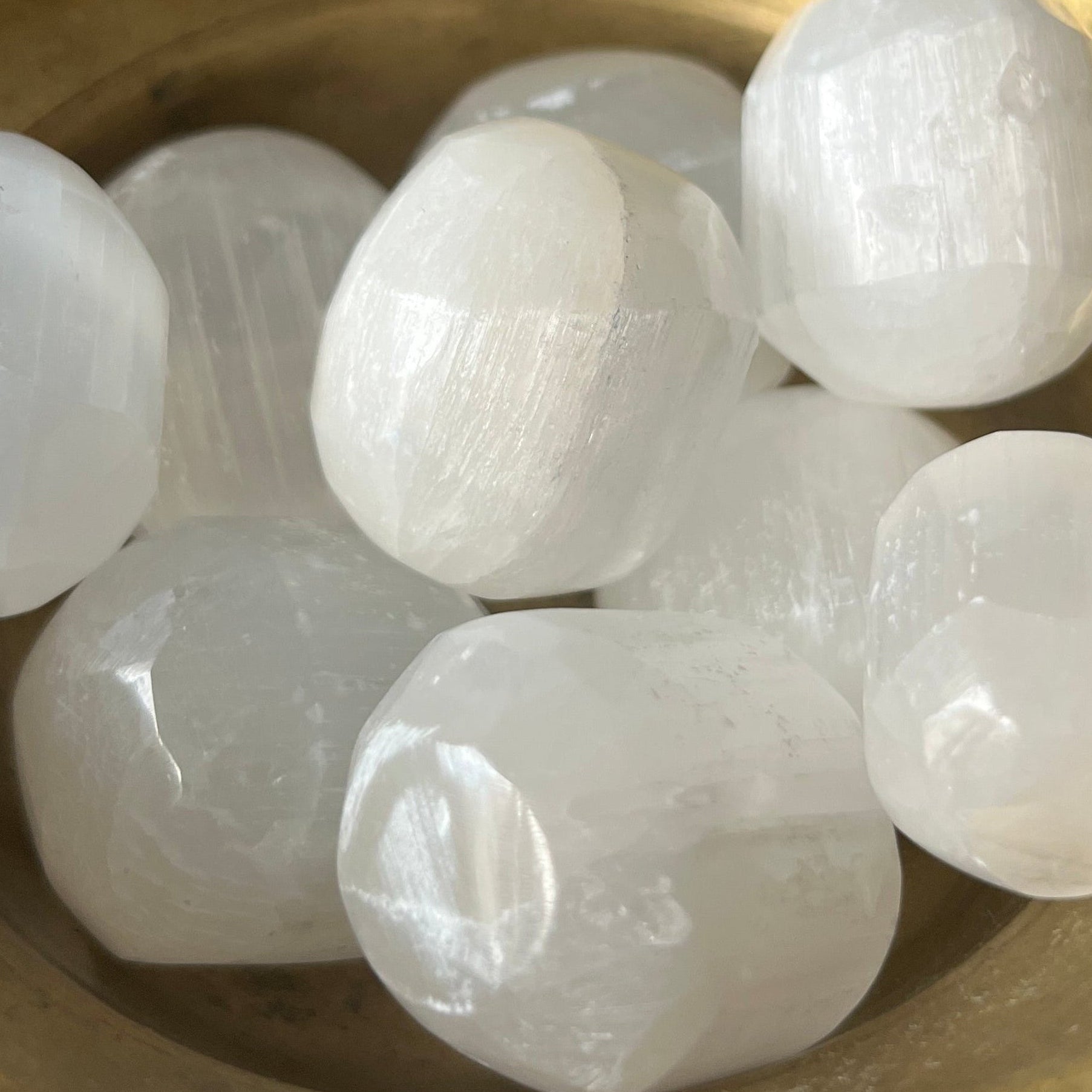 Selenite (Satin Spar) Tumblestones in a gold bowl