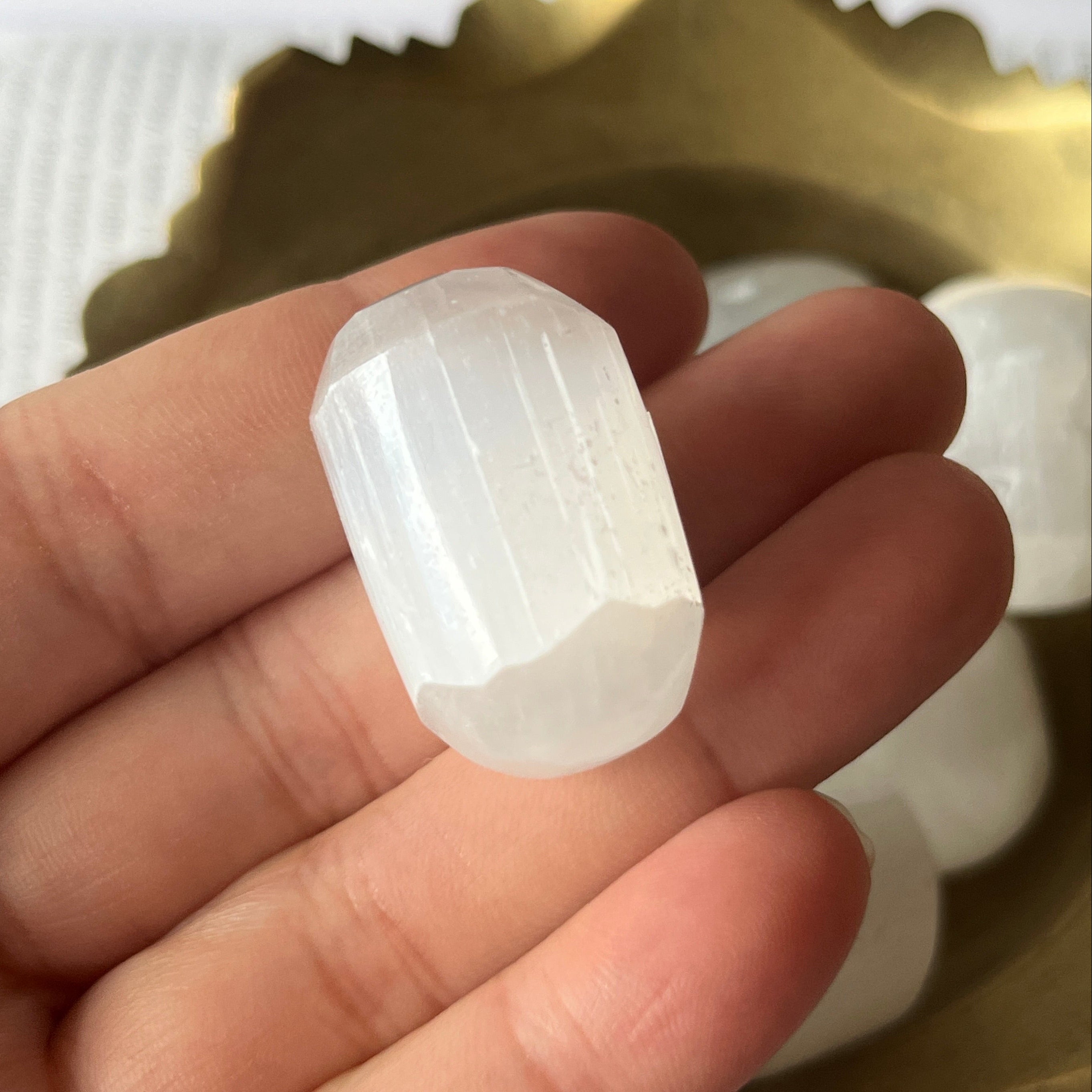 Selenite (Satin Spar) Tumblestones in a gold bowl